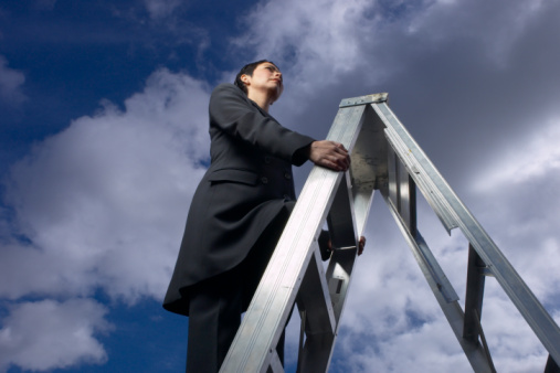 Woman climbing ladder "to success"