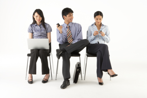 businessmen and businesswomen using social media through phones and laptop